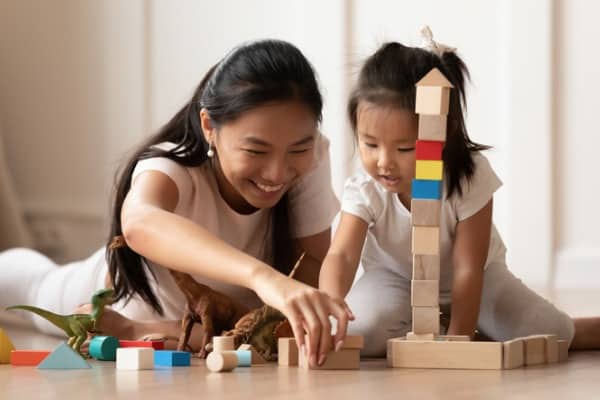 overjoyed vietnamese mother little daughter play at home
