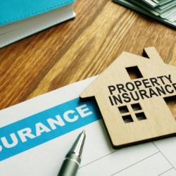 property insurance stamp on a model wooden home