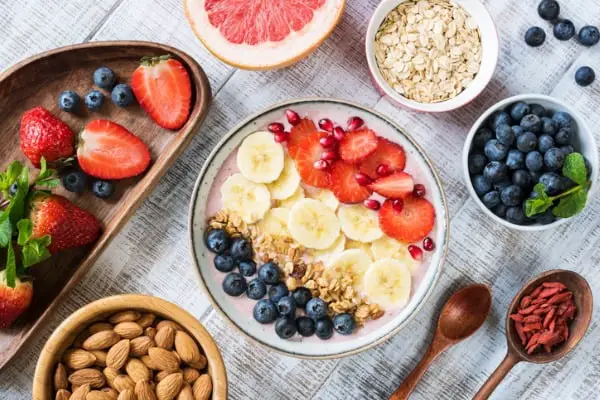smoothie bowl with banana strawberry blueberry granola