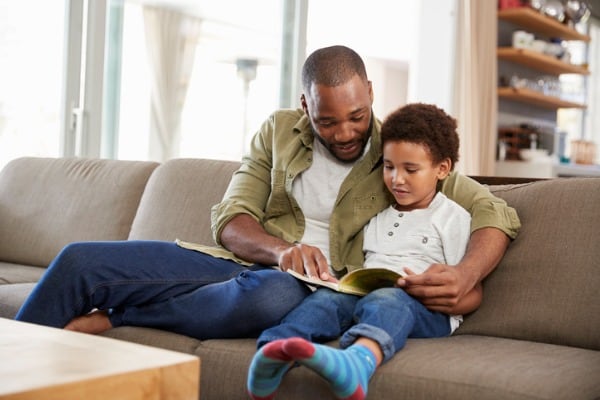 father and son reading books together