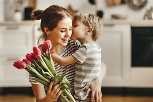 child giving flowers to mom